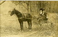 Two women in horse-drawn carriage